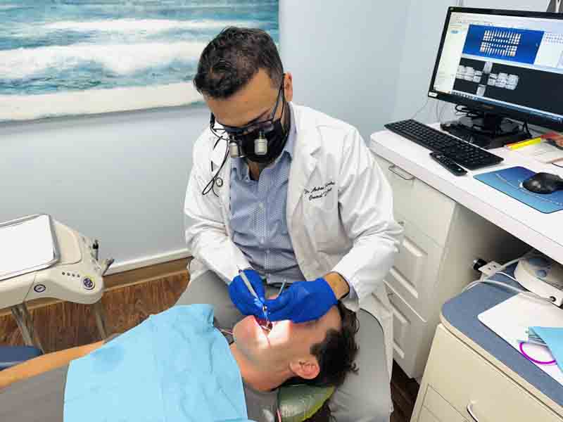 Dr. Farahat providing dental care for a new patient