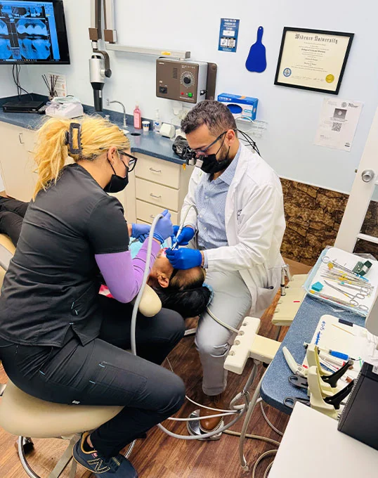 Dr. Farahat providing dental care for a patient