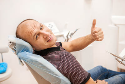 man smiling in a dental chair