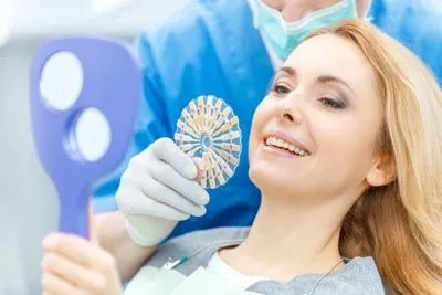 woman choosing dental veneers color at Precious Smiles Family Dentistry
