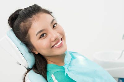 woman smiling in a dental chair