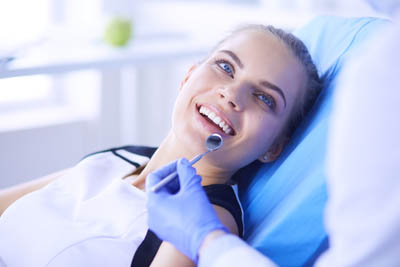 woman getting a dental checkup at Precious Smiles Family Dentistry