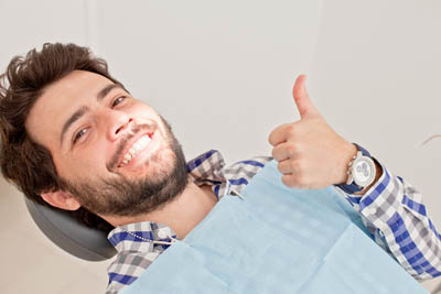 man smiling after getting his wisdom teeth removed