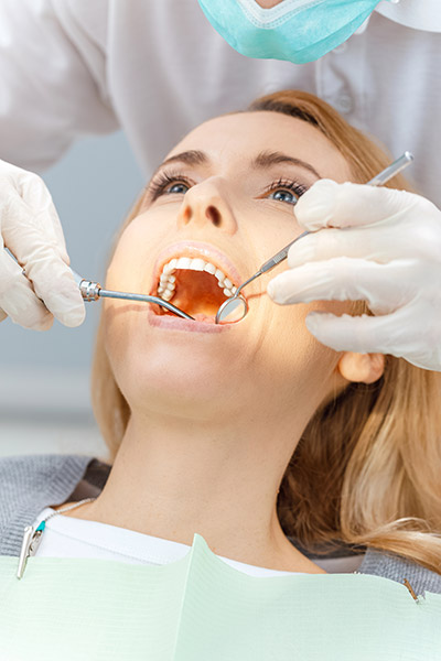 woman receiving dental care at Precious Smiles Family Dentistry